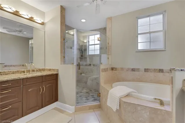 a bathroom with a granite countertop sink a toilet and shower