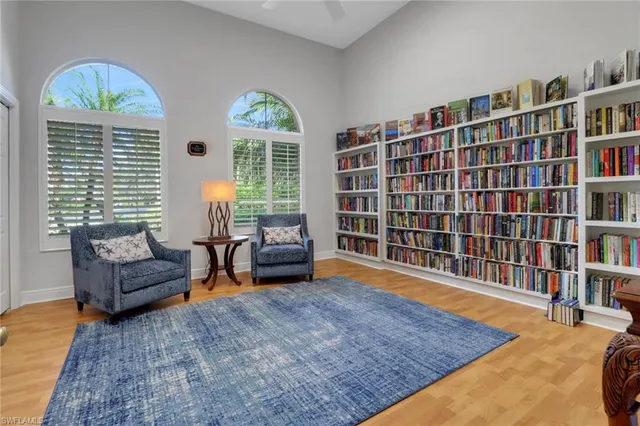a living room with furniture and a book shelf