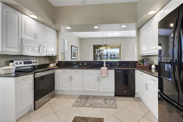 a kitchen with a sink cabinets and stainless steel appliances