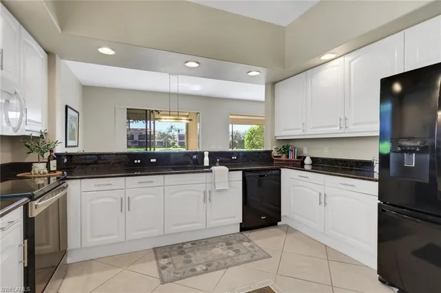 a kitchen with a sink and white cabinets