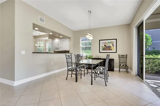 a view of a dining room with furniture and a chandelier