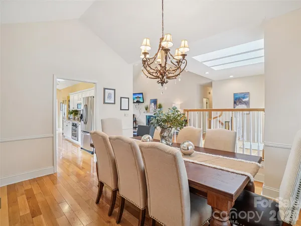a view of a dining room with furniture wooden floor and chandelier