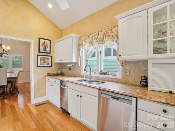 a kitchen with stainless steel appliances granite countertop a sink and cabinets