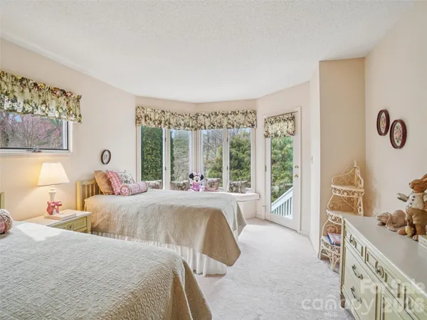 a bed room with a bed and a balcony