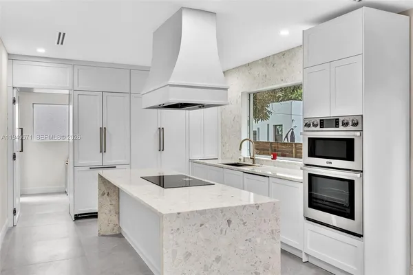 a hallway with furniture and a large window