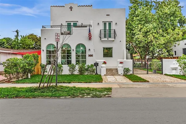 a aerial view of a house with a yard and plants