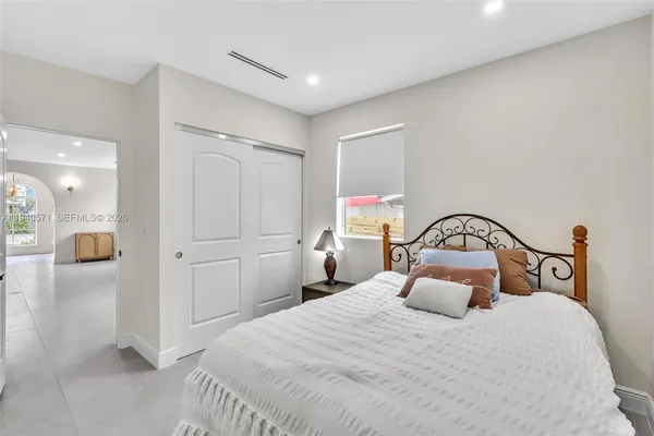 a view of a house with backyard and a tree