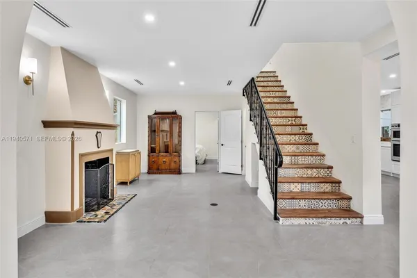 a view of staircase and fireplace with wooden floor