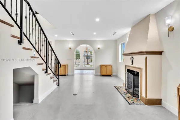 a kitchen with granite countertop a sink stove and refrigerator
