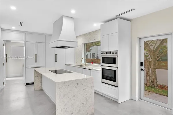 a large kitchen with a stove and a refrigerator