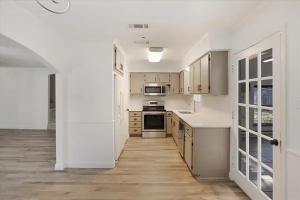 a kitchen with stainless steel appliances granite countertop a stove and a refrigerator