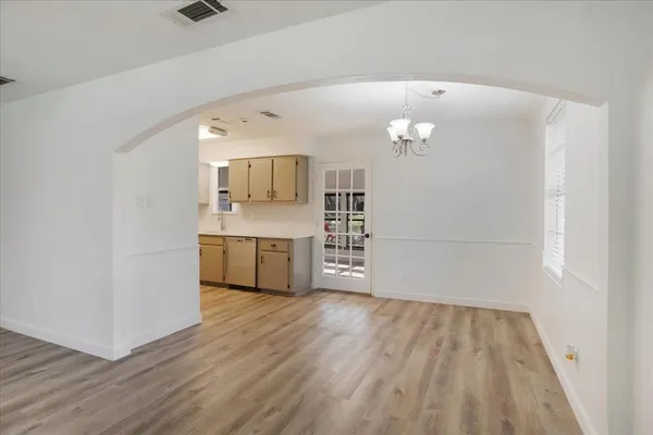 a view of a kitchen with wooden floor and a sink