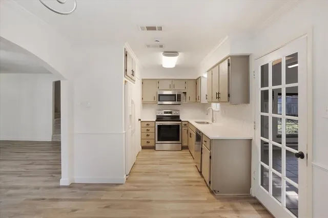 a kitchen with stainless steel appliances granite countertop a stove and a refrigerator