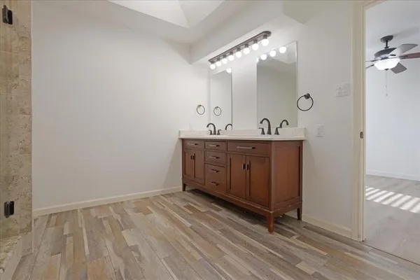 a spacious bathroom with a double vanity sink and mirror