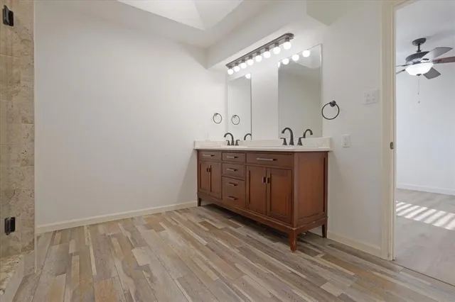 a spacious bathroom with a double vanity sink and mirror