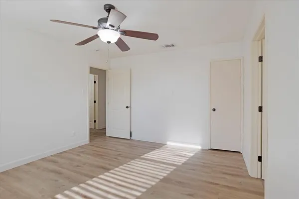 a view of a room with a ceiling fan
