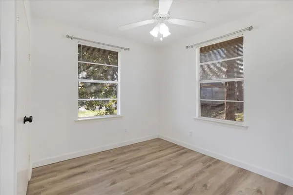 a bathroom with a granite countertop toilet sink and mirror