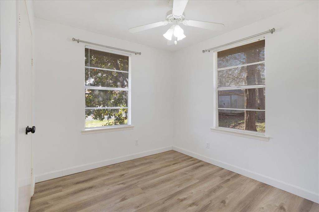 186 Mill Creek Resort Road Pottsboro, TX 75076 - Photo 23 of 35 an empty room with wooden floor closet and windows