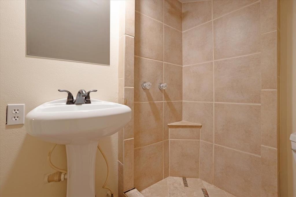 186 Mill Creek Resort Road Pottsboro, TX 75076 - Photo 28 of 36 a bathroom with a sink toilet and shower