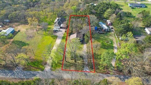 a aerial view of residential houses with yard