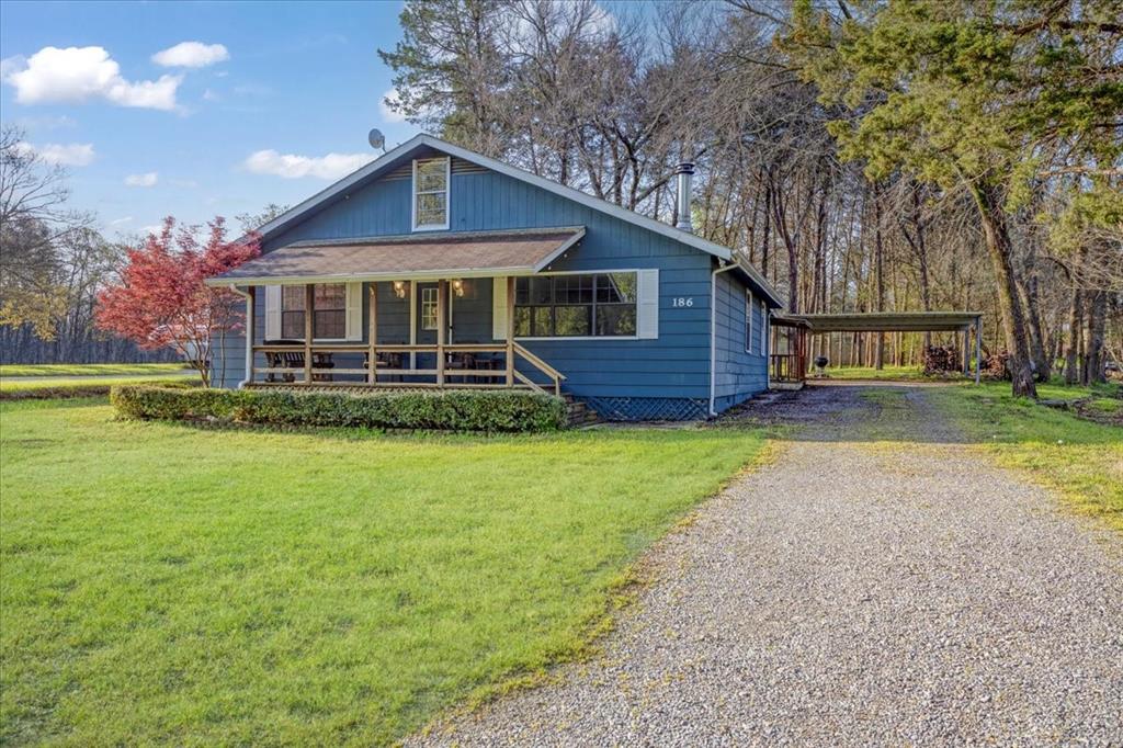 186 Mill Creek Resort Road Pottsboro, TX 75076 - Photo 35 of 35 a front view of a house with a yard