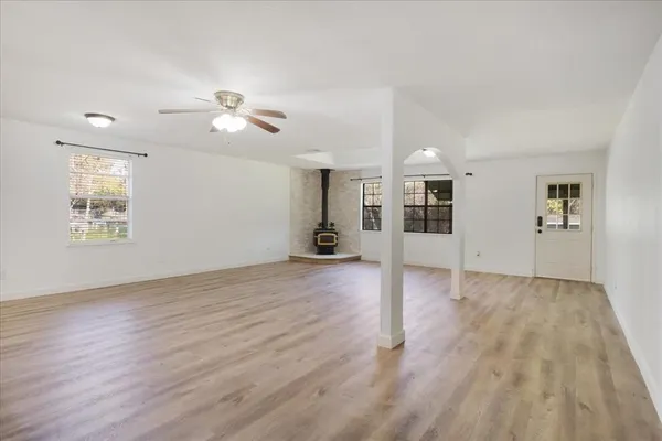 a view of a livingroom with wooden floor and a ceiling fan