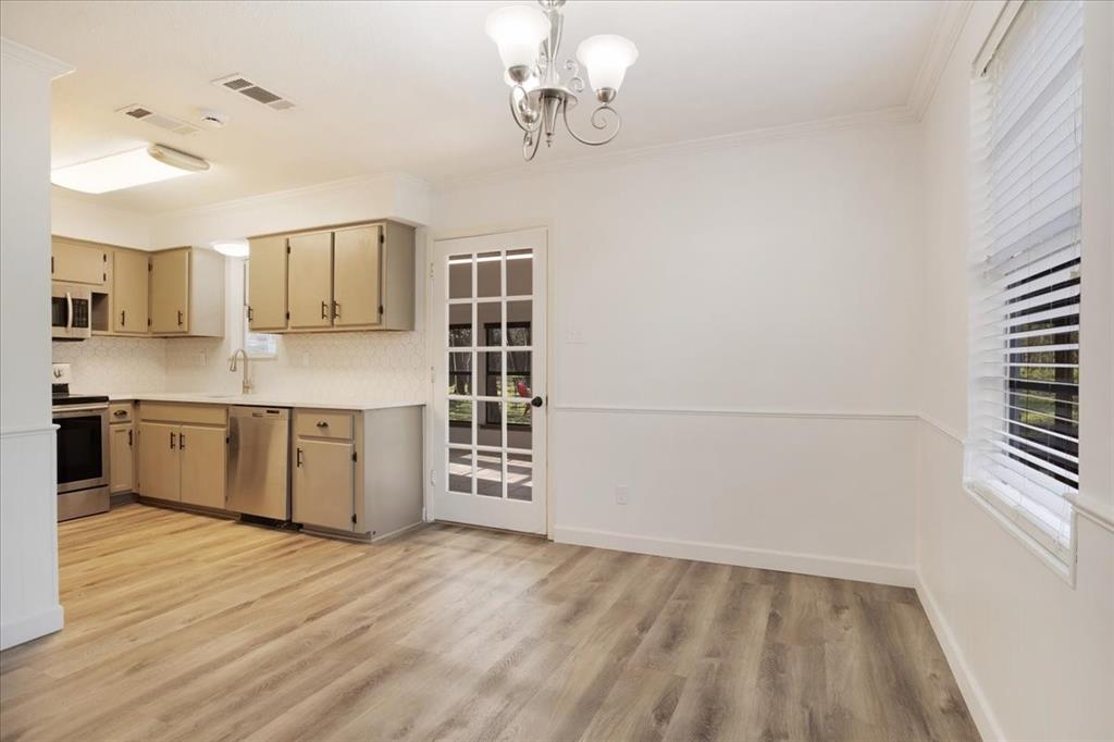186 Mill Creek Resort Road Pottsboro, TX 75076 - Photo 9 of 35 a kitchen with stainless steel appliances a sink cabinets and wooden floor