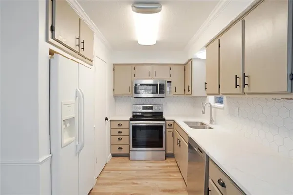 a kitchen with stainless steel appliances granite countertop a refrigerator and a stove