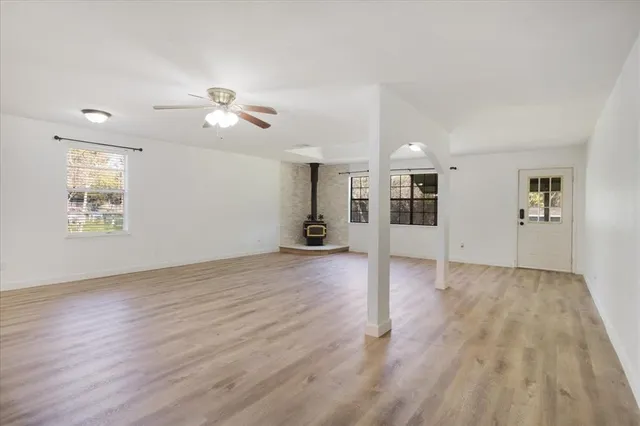 a view of a livingroom with wooden floor and a ceiling fan