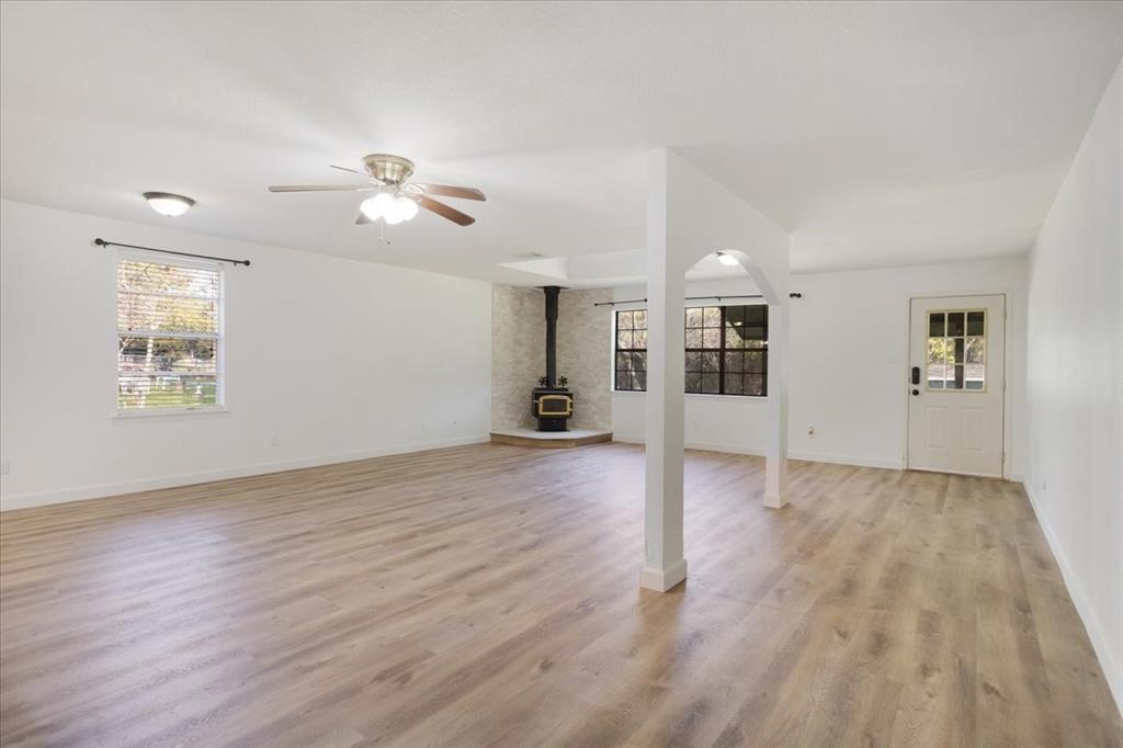 186 Mill Creek Resort Road Pottsboro, TX 75076 - Photo 10 of 36 a view of a livingroom with wooden floor and a ceiling fan