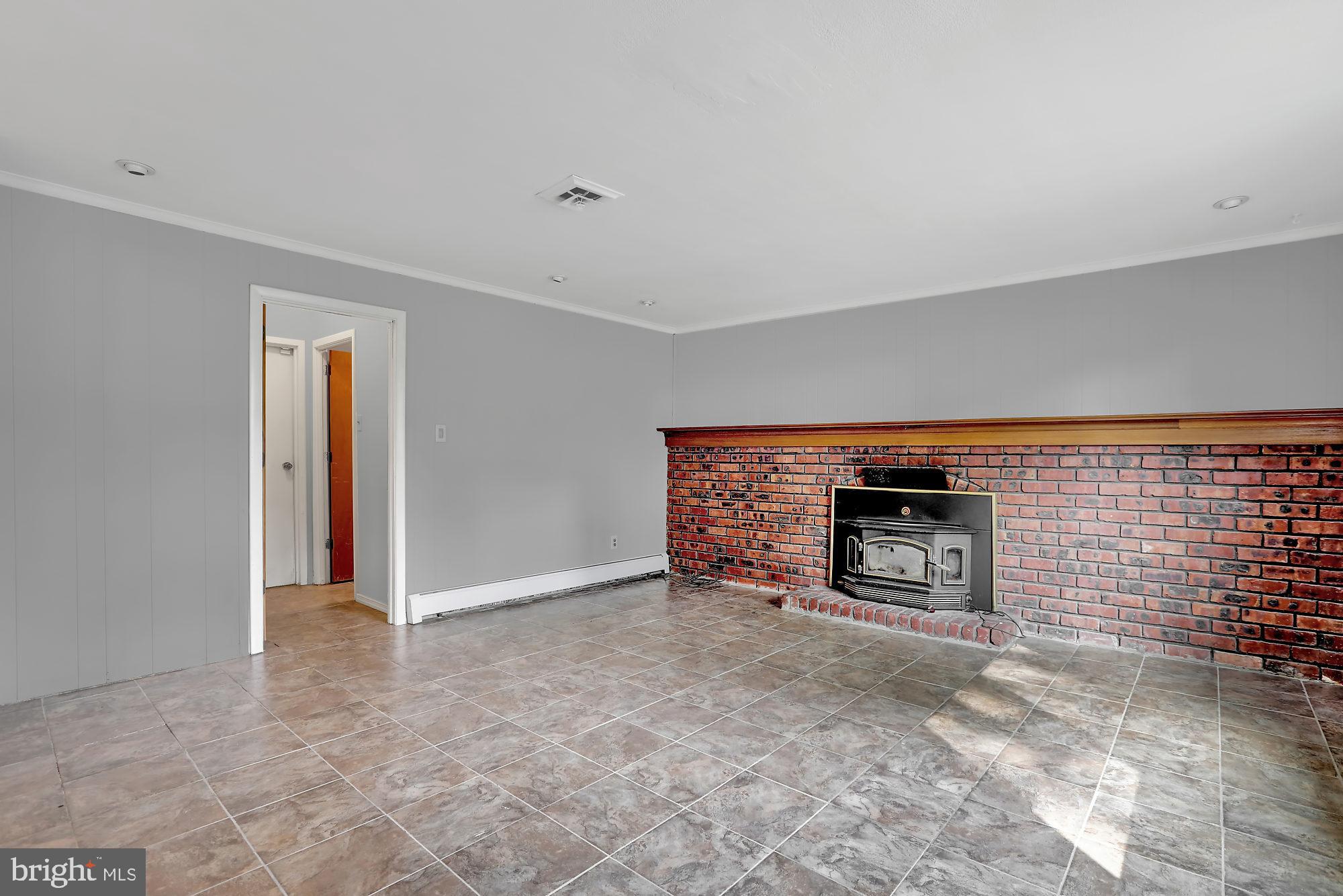 1761 Sorrel Road Warrington, PA 18976 - Photo 8 of 26 Brick mantel with wood-burning stove