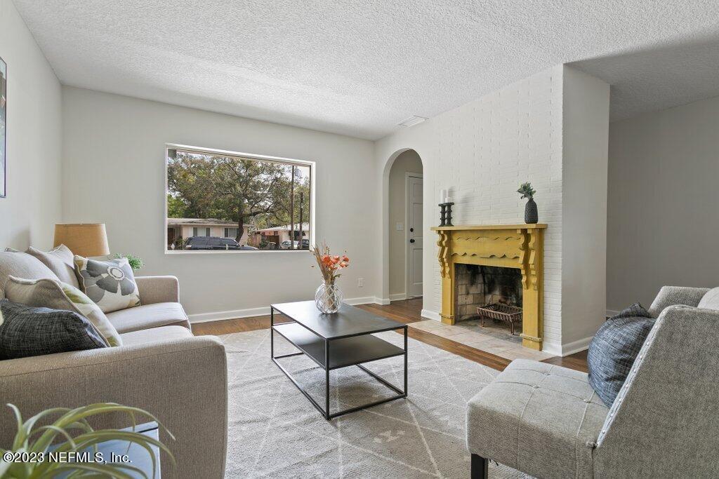 6404 Wesleyan Road Jacksonville, FL 32217 - Photo 11 of 45 a living room with furniture and a fireplace