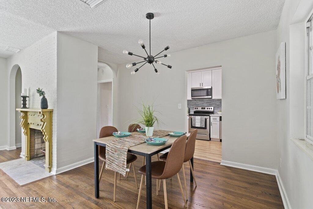 6404 Wesleyan Road Jacksonville, FL 32217 - Photo 15 of 45 a view of a dining room with furniture and wooden floor