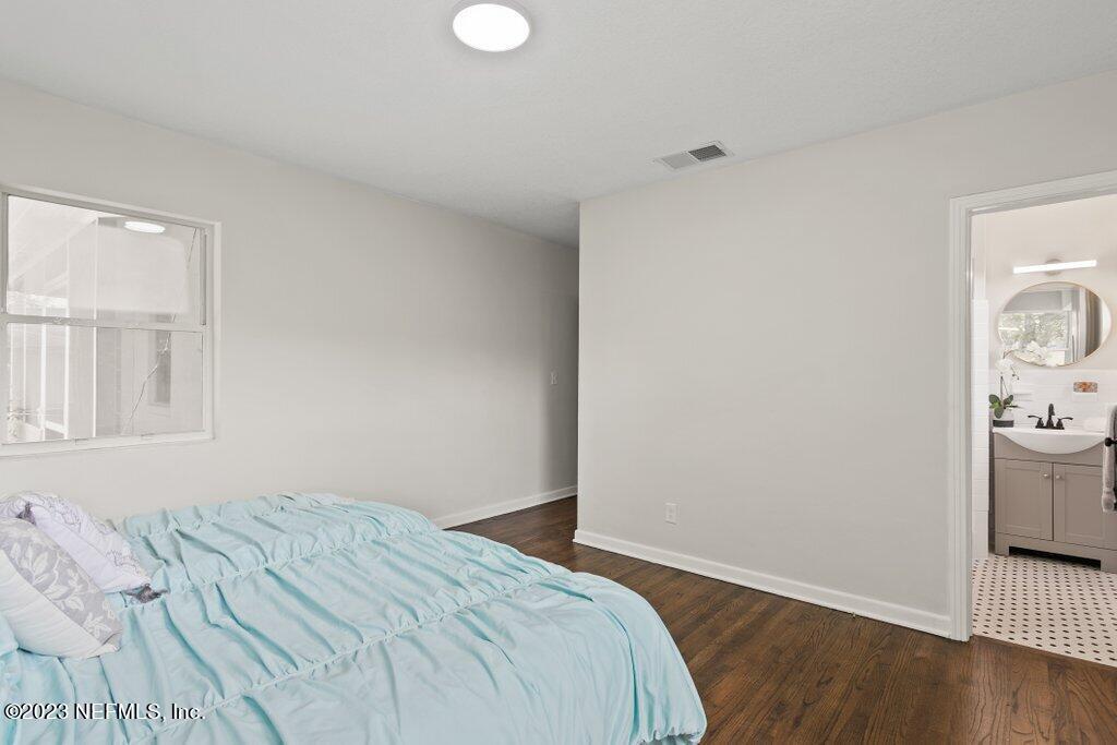 6404 Wesleyan Road Jacksonville, FL 32217 - Photo 20 of 45 a bedroom with a bed and wooden floor