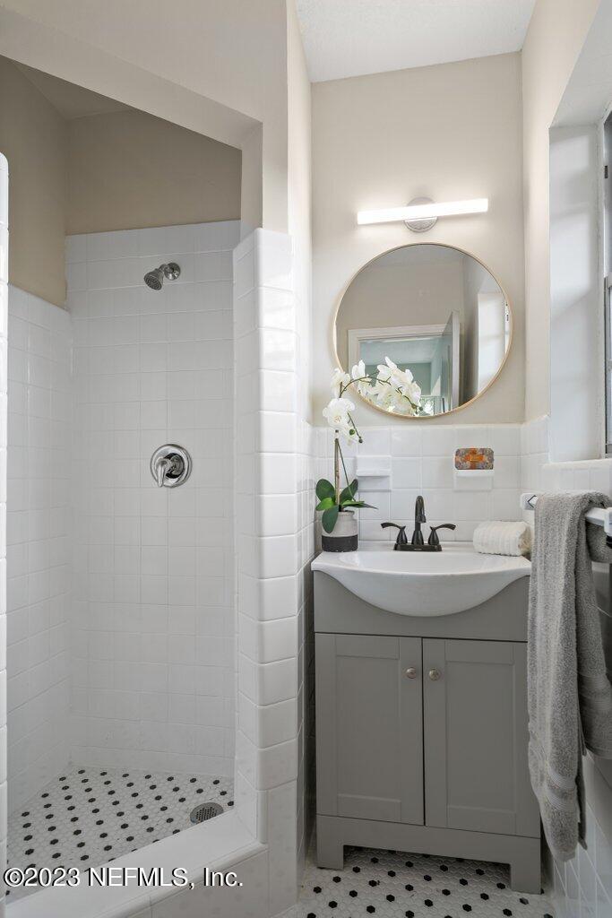 6404 Wesleyan Road Jacksonville, FL 32217 - Photo 22 of 45 a bathroom with a sink a mirror and vanity