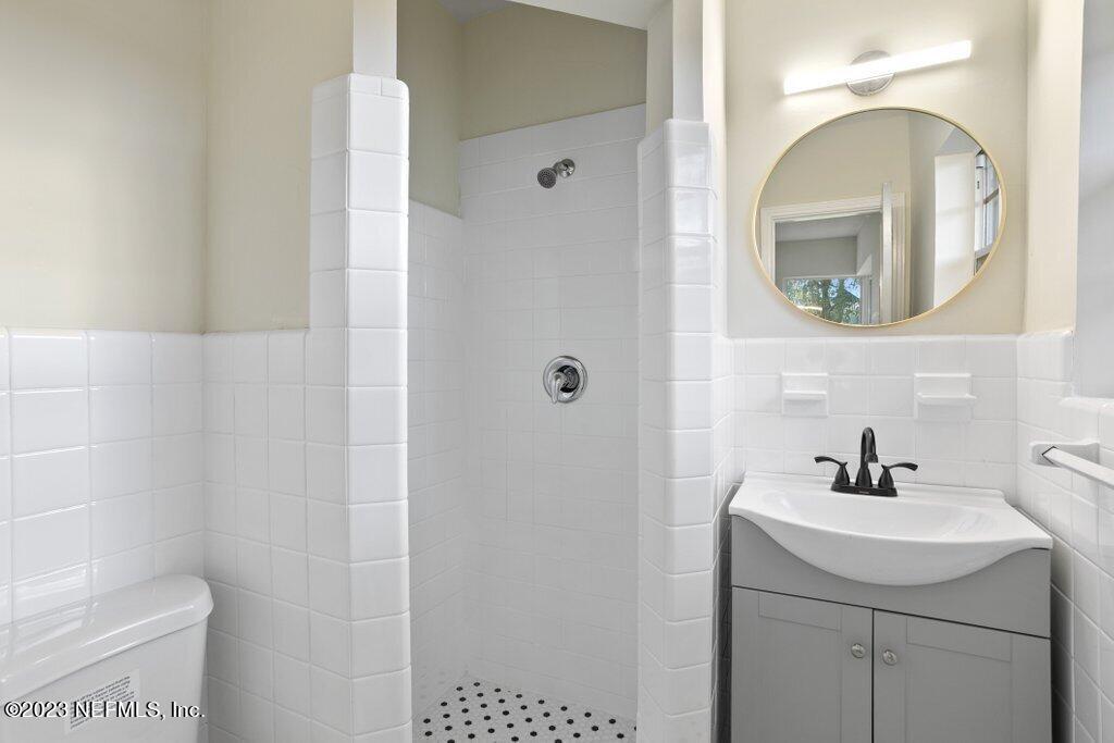 6404 Wesleyan Road Jacksonville, FL 32217 - Photo 23 of 45 a bathroom with a sink a mirror and a toilet