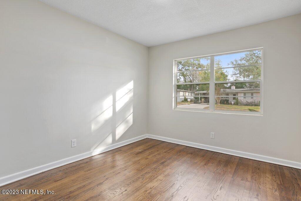 6404 Wesleyan Road Jacksonville, FL 32217 - Photo 24 of 45 an empty room with wooden floor and windows