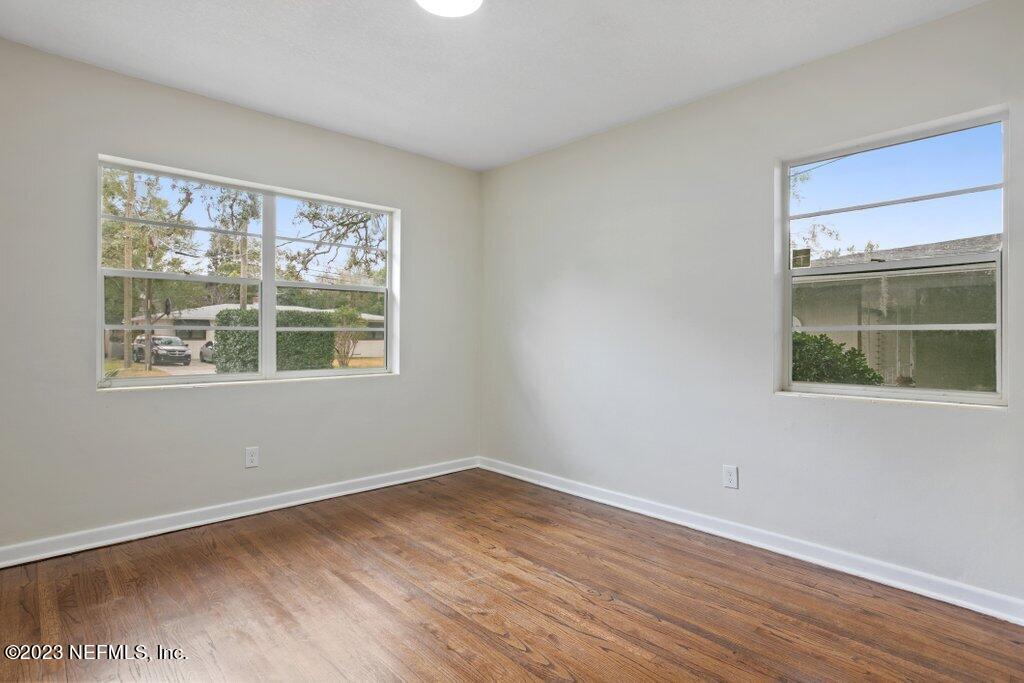 6404 Wesleyan Road Jacksonville, FL 32217 - Photo 26 of 45 a view of an empty room with wooden floor and a window