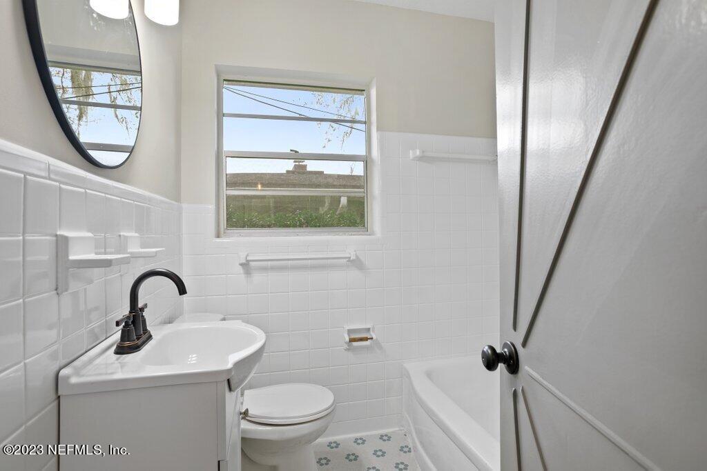 6404 Wesleyan Road Jacksonville, FL 32217 - Photo 29 of 45 a bathroom with a toilet sink and a mirror