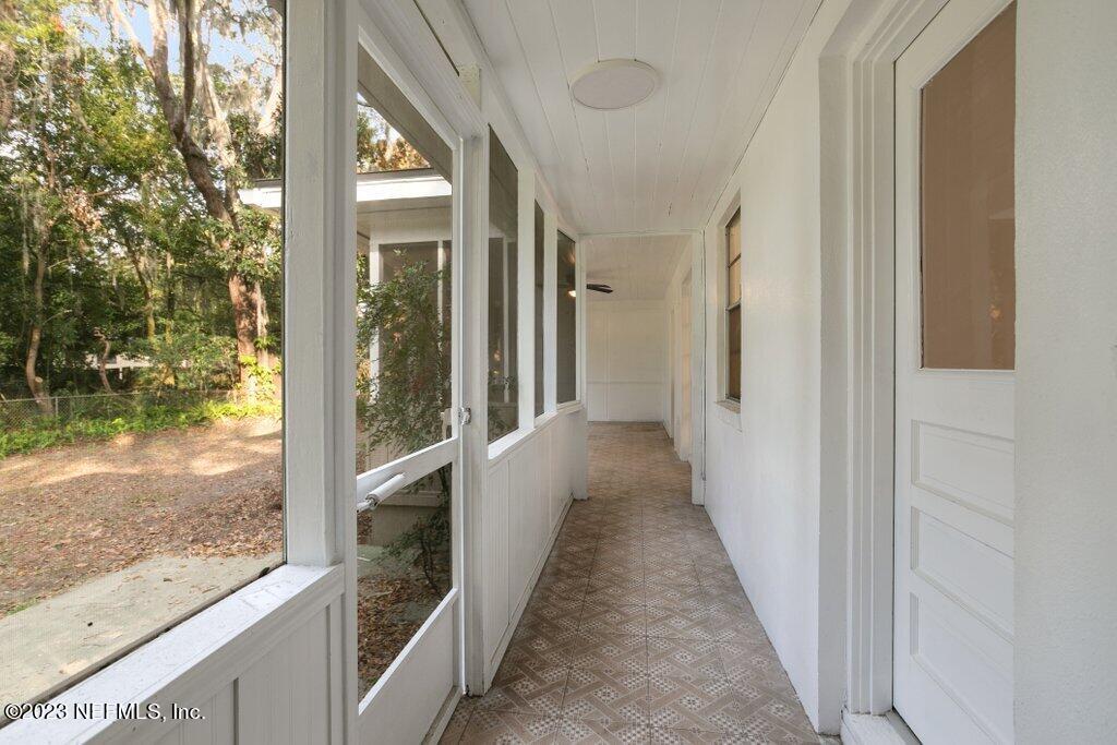 6404 Wesleyan Road Jacksonville, FL 32217 - Photo 31 of 45 a view of a hallway with wooden floor and a floor to ceiling window