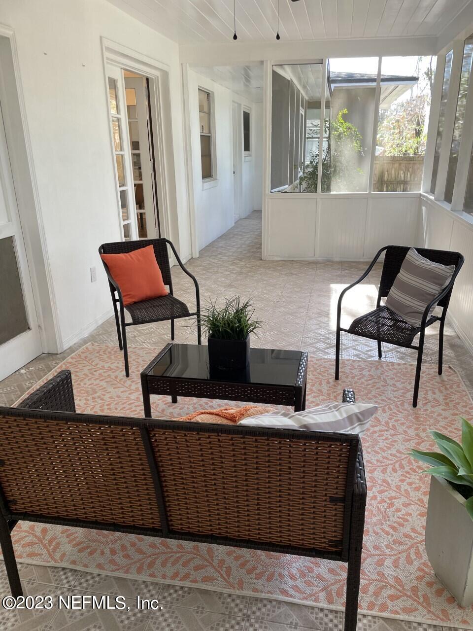 6404 Wesleyan Road Jacksonville, FL 32217 - Photo 36 of 45 a living room with furniture and a potted plant