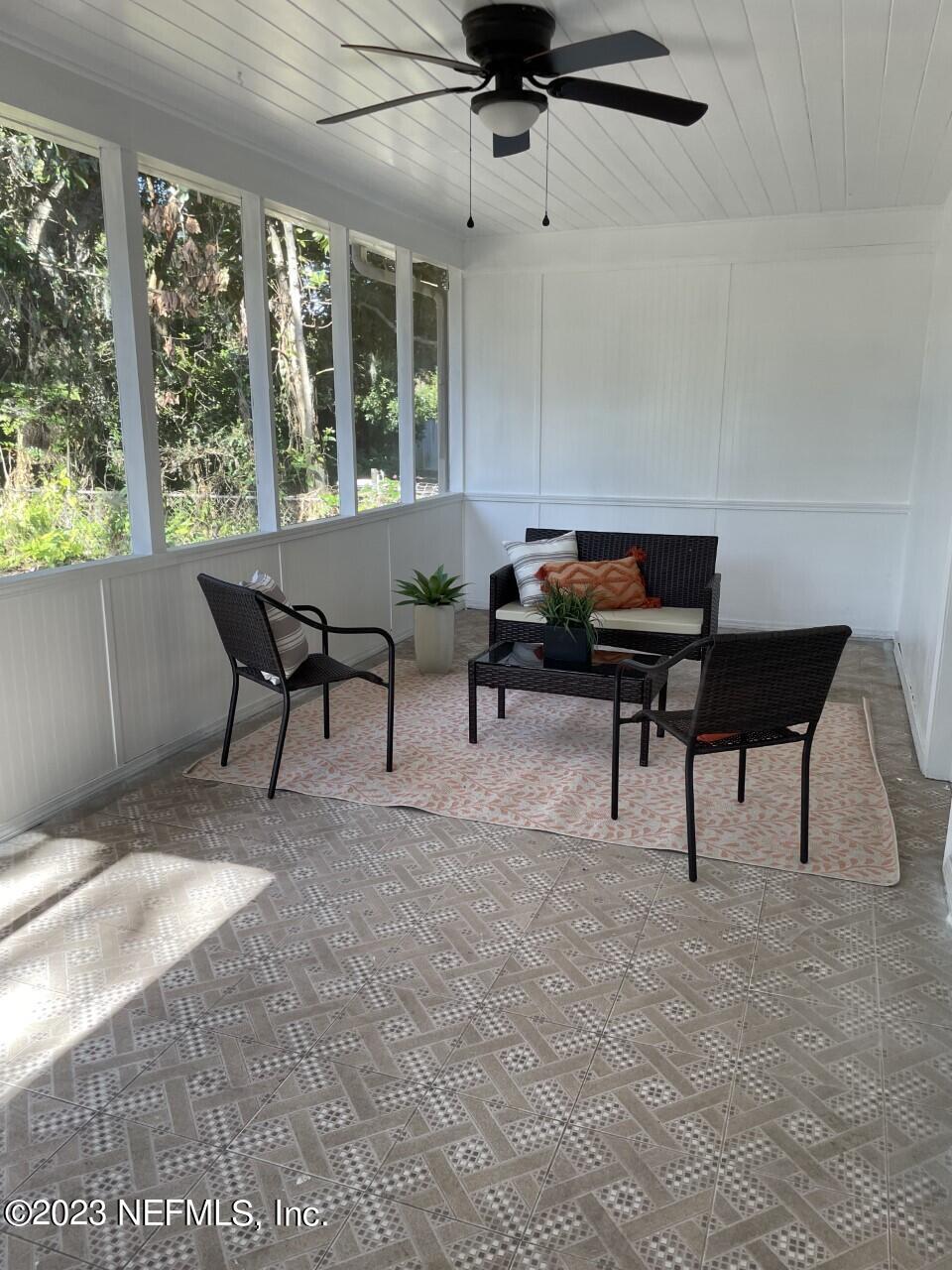 6404 Wesleyan Road Jacksonville, FL 32217 - Photo 37 of 45 a living room with furniture and a piano
