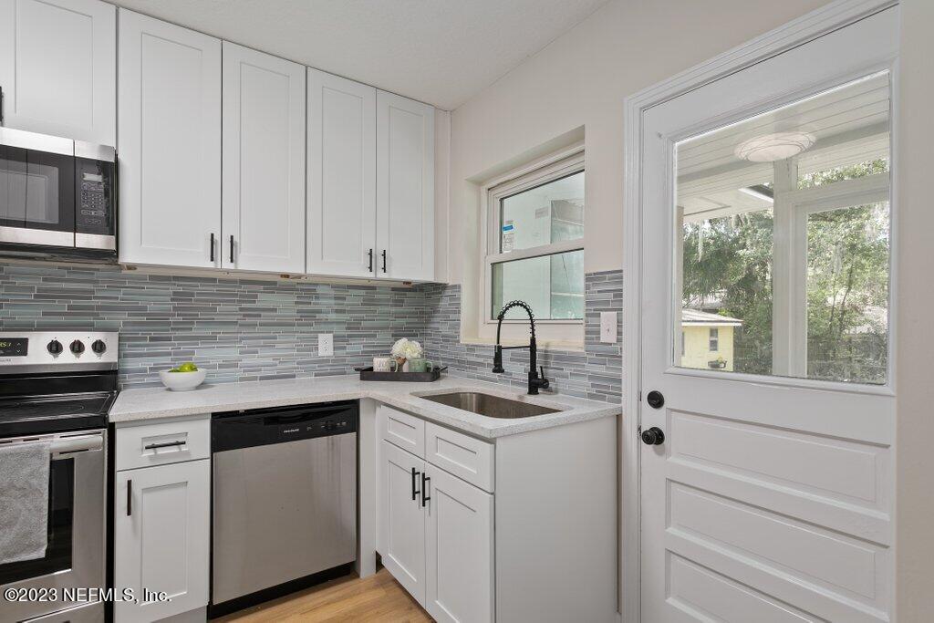 6404 Wesleyan Road Jacksonville, FL 32217 - Photo 6 of 45 a kitchen with white cabinets and white appliances