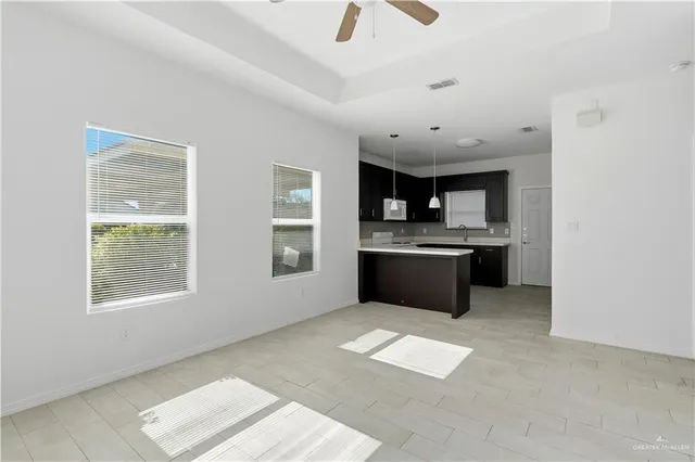 a large kitchen with cabinets and stainless steel appliances