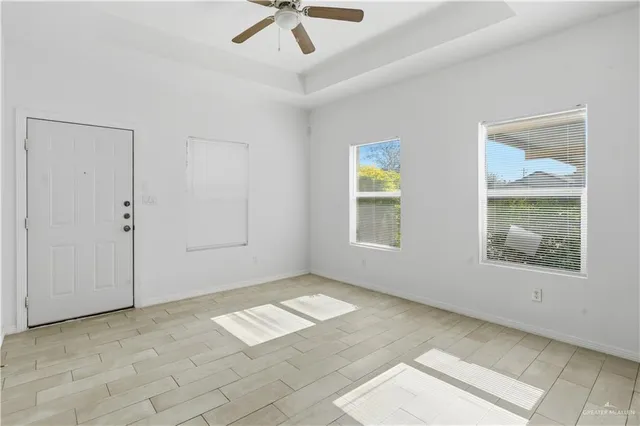 an empty room with windows and closet