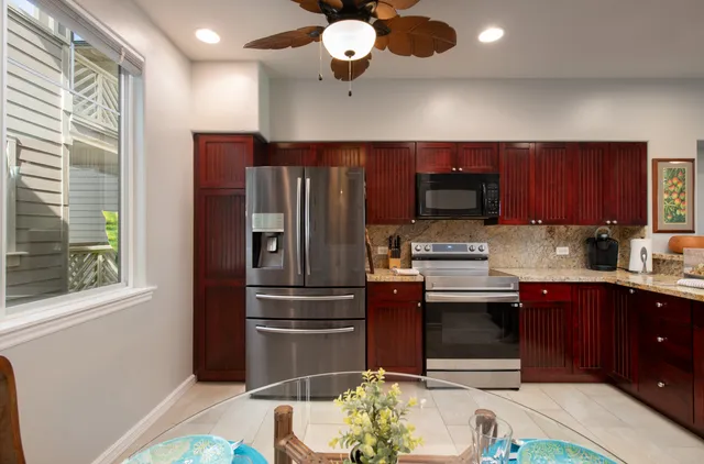 a kitchen with stainless steel appliances granite countertop a refrigerator and a sink