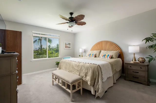 a spacious bedroom with a bed and a window