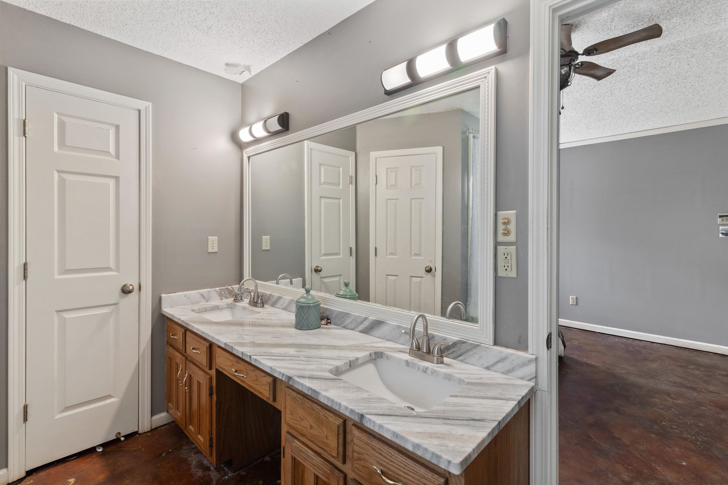 6712 Booth Forrest Drive Bartlett, TN 38135 - Photo 18 of 27 a bathroom with a granite countertop sink and a mirror