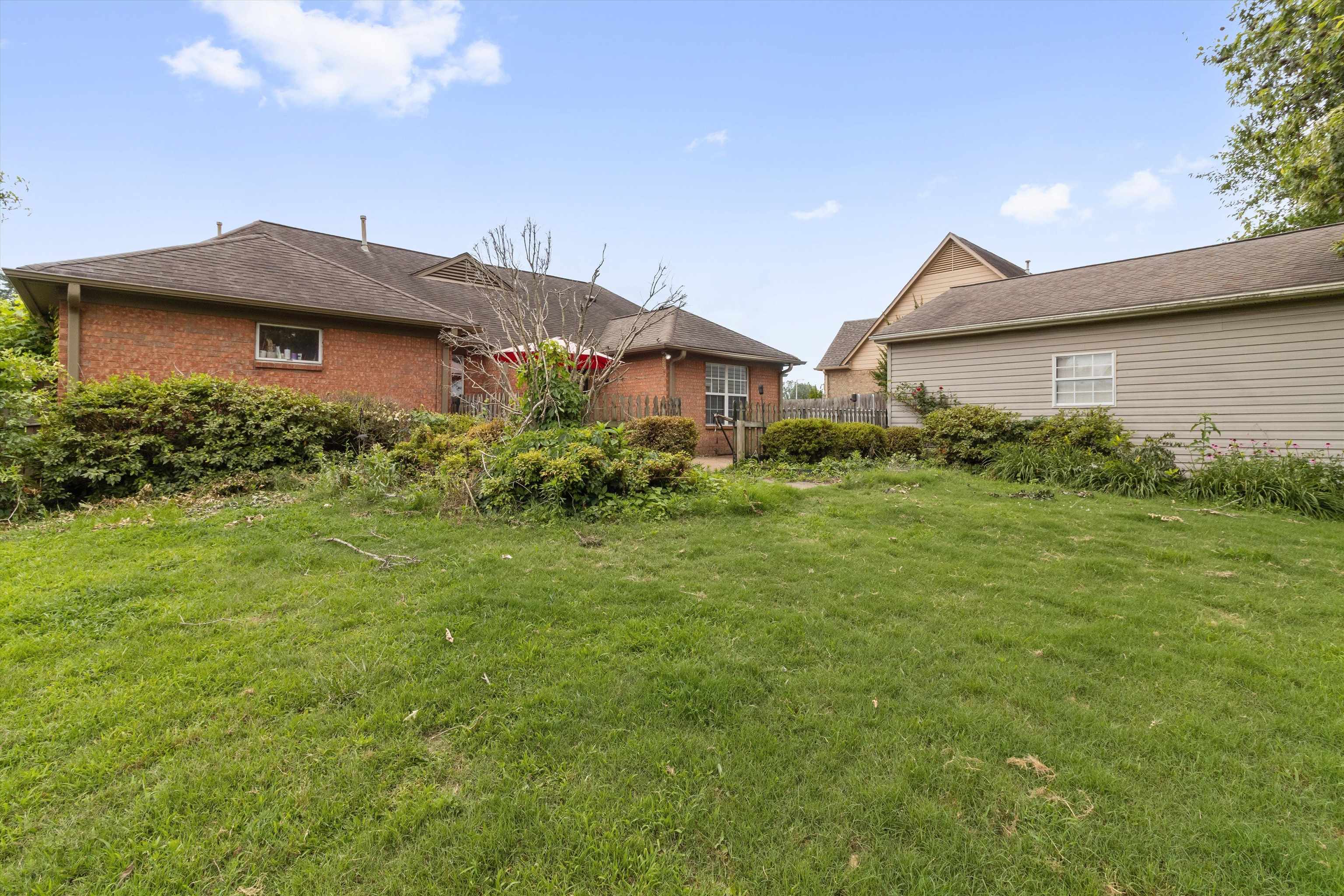 6712 Booth Forrest Drive Bartlett, TN 38135 - Photo 27 of 27 a view of a brick house next to a yard