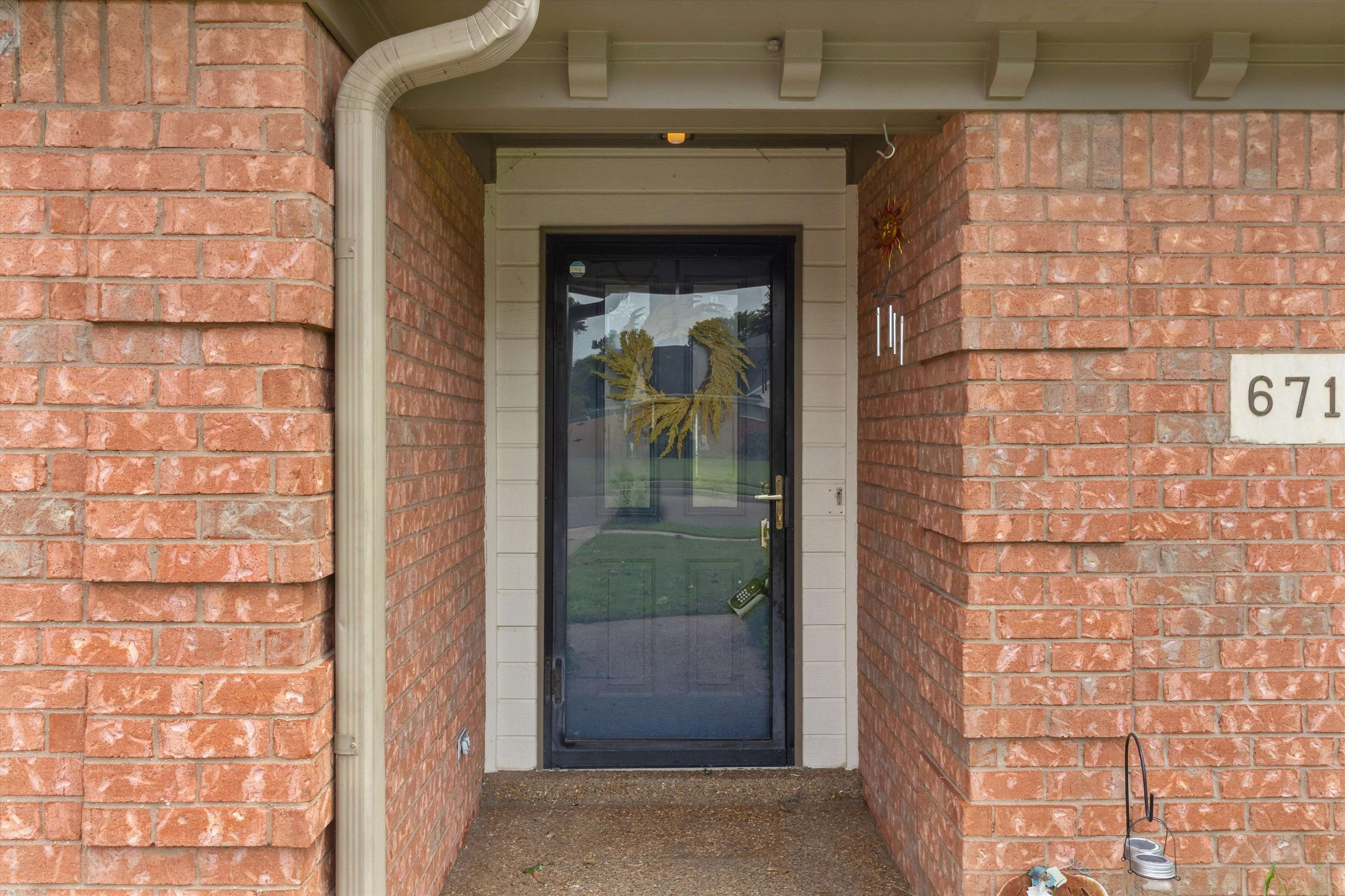 6712 Booth Forrest Drive Bartlett, TN 38135 - Photo 3 of 27 a view of a brick house with a small space